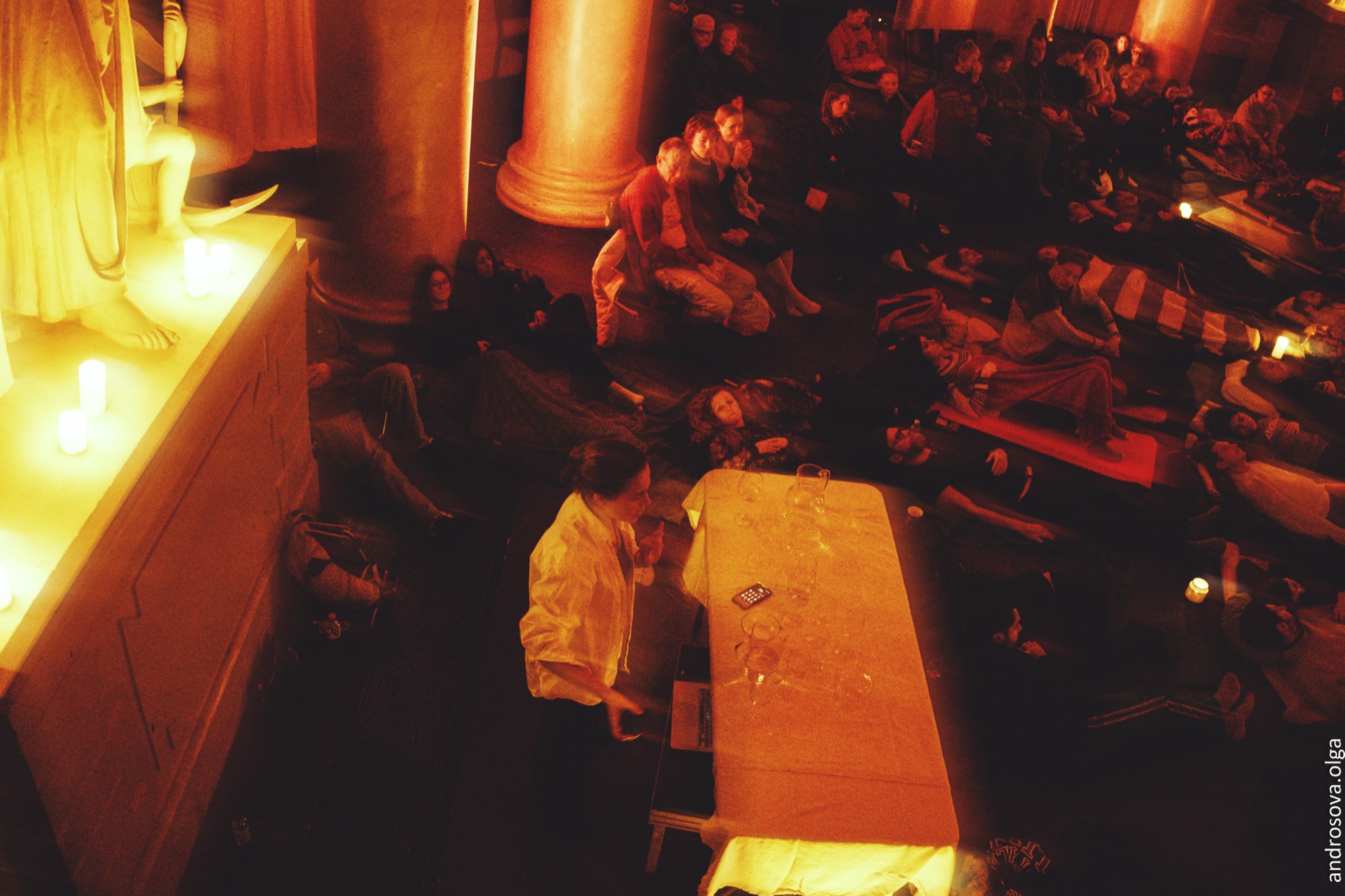 Audience lying among candles at a Lumen Project happening, photographed by Olga Androsova